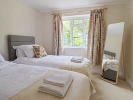 A bedroom with two beds and a mirror at Harbins Farm Glanvilles Wootton Nr. Sherborne