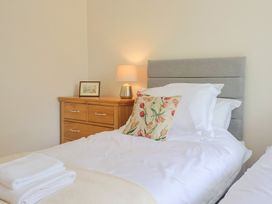A bedroom with two beds and a lamp on the dressing table at Harbins Farm Glanvilles Wootton Nr. Sherborne