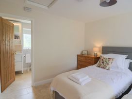 A bedroom with a bed and bedside table at Harbins Farm in Glanvilles Wootton Nr. Sherborne