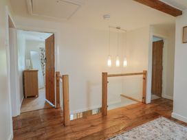 A hallway with wooden flooring and light fixtures at Harbins Farm Glanvilles Wootton Nr. Sherborne