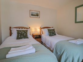 A bedroom with two single beds and a nightstand at Harbins Farm Glanvilles Wootton Nr. Sherborne