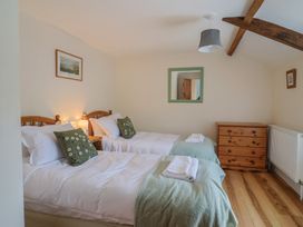 A bedroom with two beds and a dresser at Harbins Farm, Glanvilles Wootton Nr. Sherborne