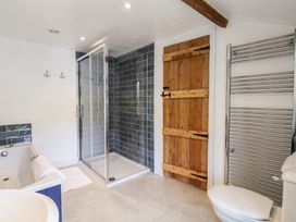 A bathroom with a shower, bathtub and towel rail at Harbins Farm in Glanvilles Wootton Nr. Sherborne