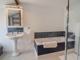 A bathroom with a bathtub and wash basin at Harbins Farm Glanvilles Wootton Nr. Sherborne