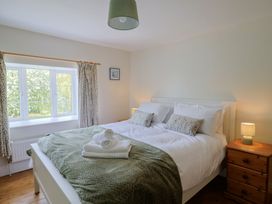 A bedroom with a bed and lamp at Harbins Farm Glanvilles Wootton Nr. Sherborne