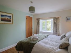 A bedroom with a bed and window at Harbins Farm Glanvilles Wootton Nr. Sherborne