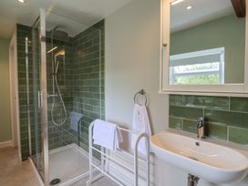 A bathroom with a shower and sink at Harbins Farm Glanvilles Wootton Nr. Sherborne