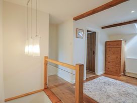 A hallway with wooden flooring and a chest of drawers at Harbins Farm Glanvilles Wootton Nr. Sherborne