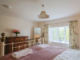 A bedroom with a bed and a dresser at Harbins Farm Glanvilles Wootton Nr. Sherborne