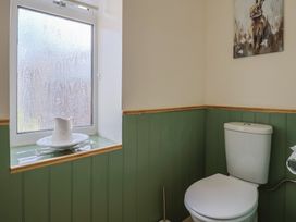 A bathroom with a toilet and window at Harbins Farm in Glanvilles Wootton Nr. Sherborne
