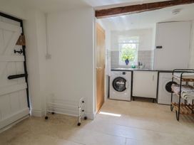 A laundry room with washing machine and drying rack at Harbins Farm in Glanvilles Wootton Nr. Sherborne