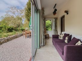 A conservatory with a sofa and chairs at Harbins Farm Glanvilles Wootton Nr. Sherborne