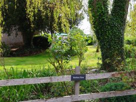 A garden area with trees and a sign at Harbins Farm in Glanvilles Wootton Nr. Sherborne