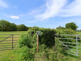 A gate with a walking sign in a grassy field at Harbins Farm Glanvilles Wootton Nr. Sherborne