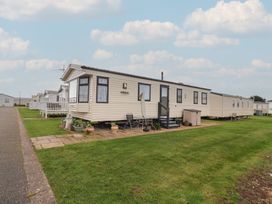 A mobile home with steps and outdoor chairs at Winchester - 244