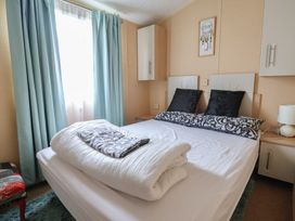 A bedroom with a bed and nightstand at Winchester - 244