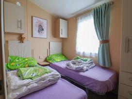 A bedroom with two beds and cabinets at Winchester - 244