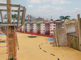 A playground area with playhouses and climbing frames at Winchester - 244