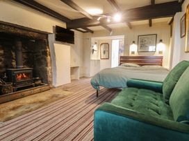 A bedroom with a bed and fireplace at Ninevah in St. Ives