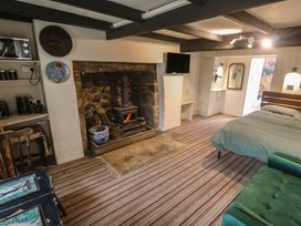 A living room with a fireplace and stove at Ninevah in St. Ives