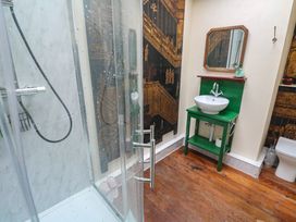 A bathroom with a shower, sink, and toilet at Ninevah in St. Ives