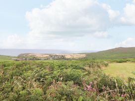 A landscape showing fields and hills with an ocean view at Ninevah in St. Ives