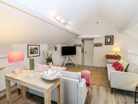 A living room with a sofa and coffee table at The Byre in Conwy