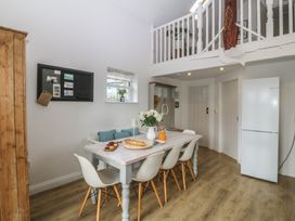 A dining room with a table and chairs at The Byre in Conwy