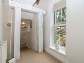 A hallway with a window and door at The Byre in Conwy
