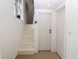 A hallway with stairs and doors at The Byre in Conwy