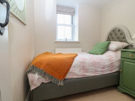 A bedroom with a bed and a nightstand at The Byre in Conwy