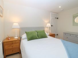 A bedroom with a bed and nightstands at The Byre in Conwy