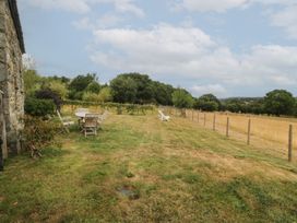 A garden area with a table and chairs at The Byre in Conwy