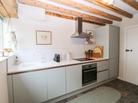 A kitchen with a sink and stove at Little Oak near Tal-Y-Bont