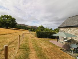 An outdoor area with a pathway and seating at Little Oak near Tal-Y-Bont