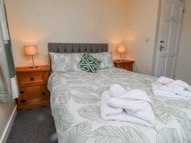 A bedroom with a bed and bedside lamps at Hen Fecws Rhoshirwaun near Sarn Meyllteyrn
