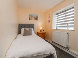 A bedroom with a single bed and bedside table at Hen Fecws in Rhoshirwaun near Sarn Meyllteyrn