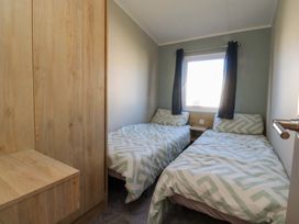 A bedroom with twin beds and a wardrobe at Plot B2 Crozzers Place in Morecambe
