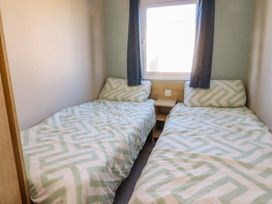 A bedroom with two beds and a window at Plot B2 Crozzers Place Morecambe