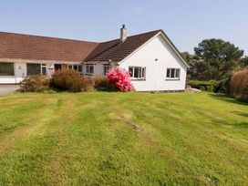 A house with a flowering shrub in the garden at Tregoning in Lostwithiel