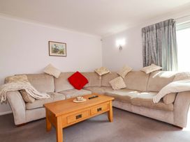 A living room with a sofa and coffee table at Tregoning in Lostwithiel