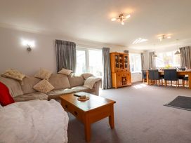 A living room with a sofa and dining table at Tregoning in Lostwithiel