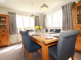 A dining room with a table set for meals at Tregoning in Lostwithiel