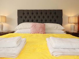 A bed with pillows and towels at Tregoning in Lostwithiel