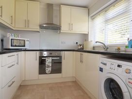 A kitchen with appliances and cabinets at Tregoning in Lostwithiel