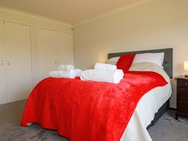 A bedroom with a bed and towels at Tregoning in Lostwithiel