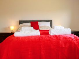 A bedroom with a bed and towels at Tregoning in Lostwithiel