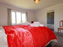 A bedroom with a bed and towels arranged on it at Tregoning in Lostwithiel