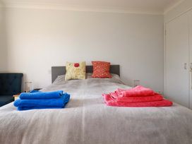A bedroom with a bed and towels at Tregoning in Lostwithiel