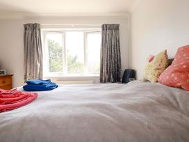 A bedroom with pillows and towels on the bed at Tregoning in Lostwithiel